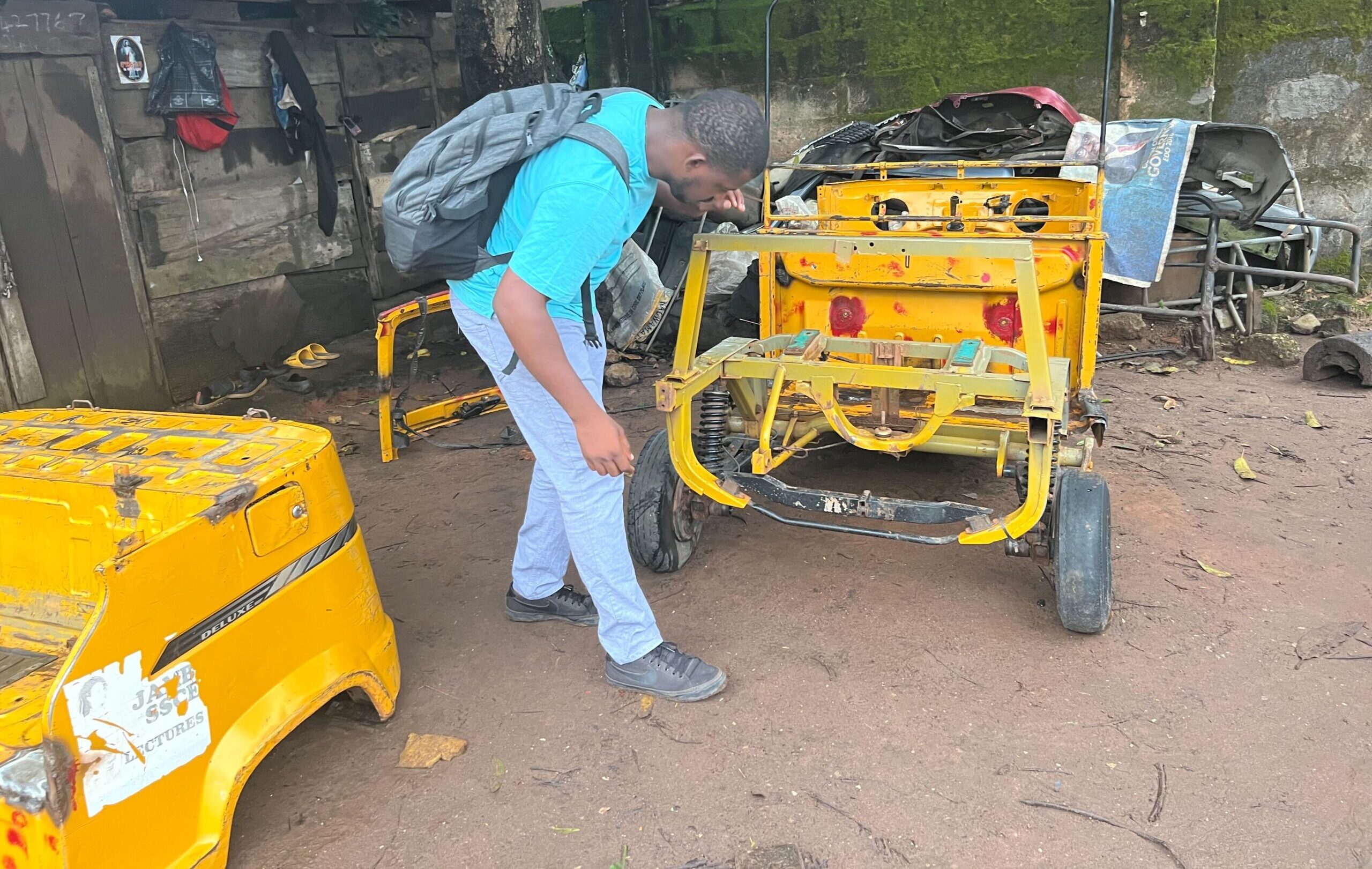 Anthony Ighomuaye looks at rickshaw in preparation for solar power conversion