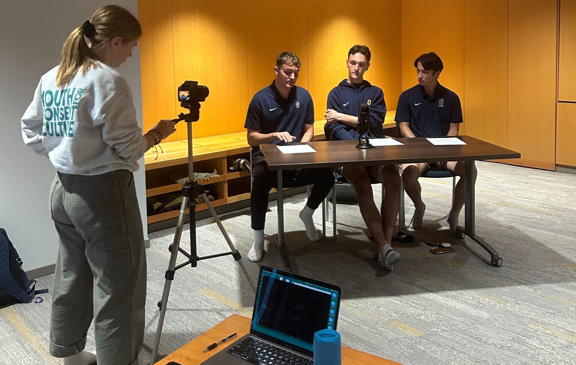 Aubrey filming with Queen's varsity student athletes