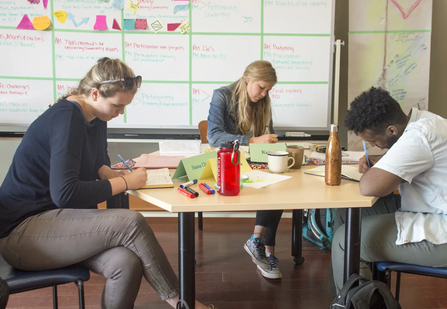 A group of students at their desks in a classroom setting.